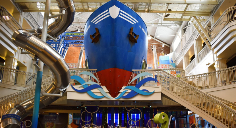 A front view of Port Discovery's multi-story Port Exhibit, which features a giant blue ship called the S.S. Friendship