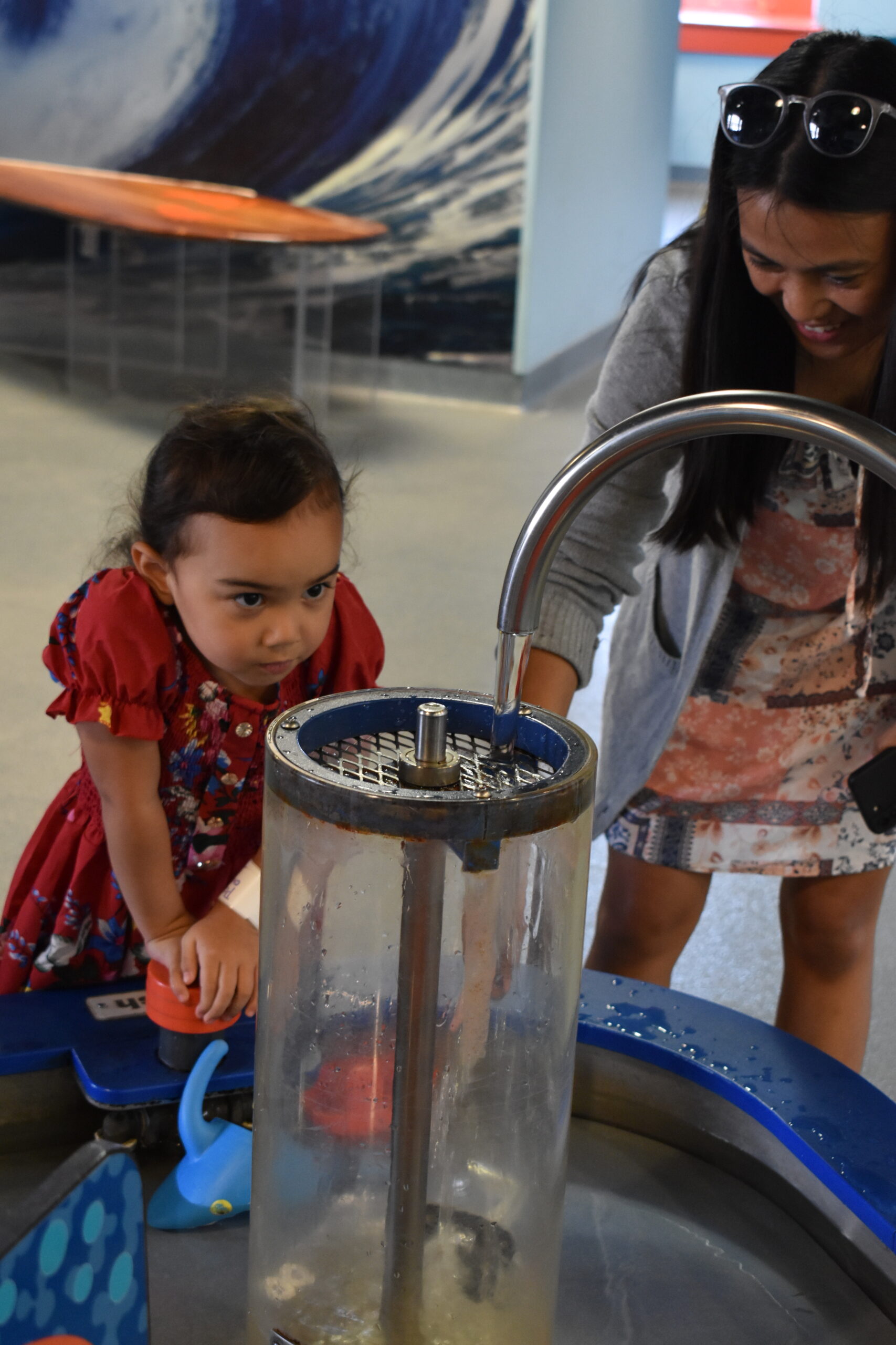 young girl working with water exhibit