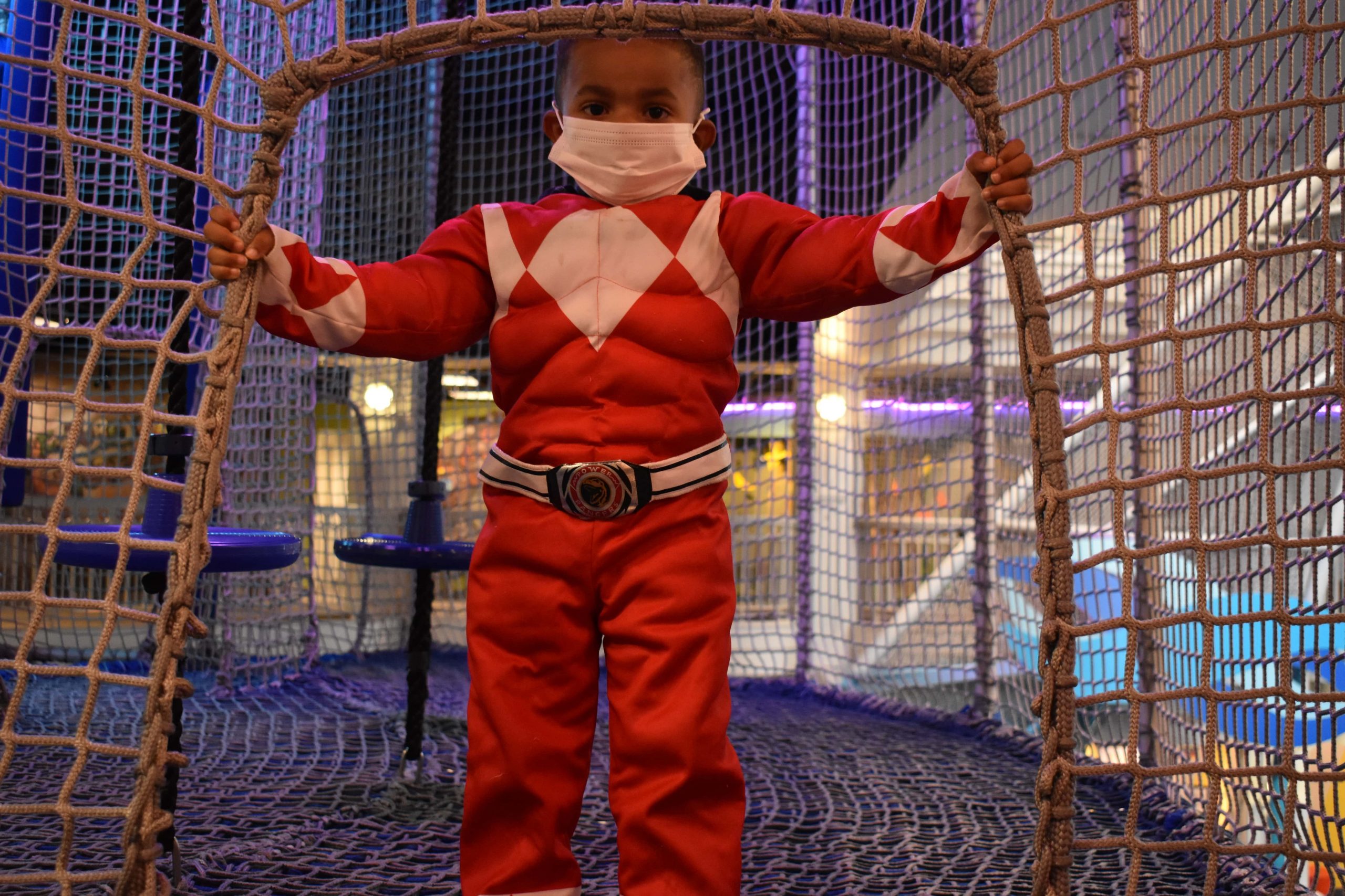 Boy dressed in costume stands in the Port Discovery Overlook open play area
