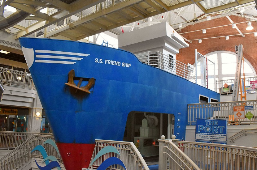 A sideview A giant blue ship named the S.S. Friendship that juts out from the back wall of Port Discovery Children's Museum.