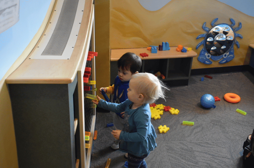 toddlers play in tot trails exhibit at Port Discovery Children's Museum
