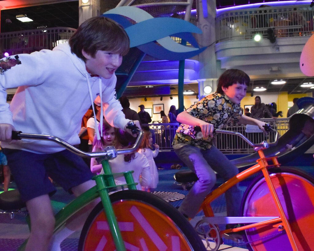 two boys riding on bikes