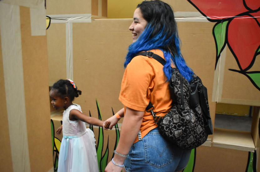 child leads adult through a box maze at Port Discovery Children's Museum