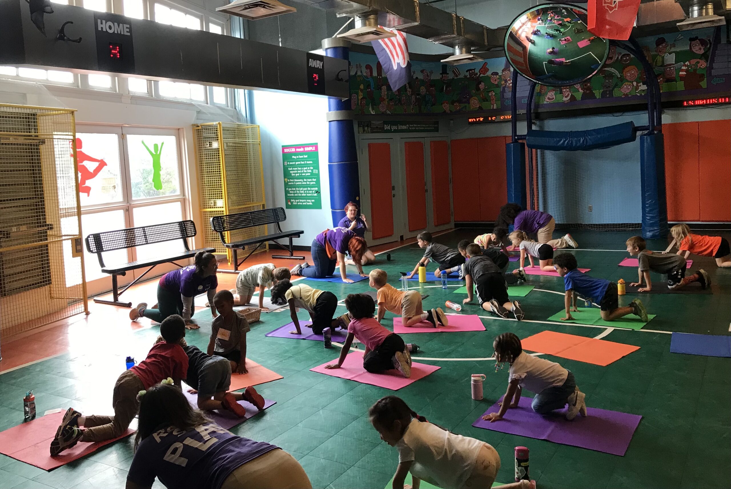 Kids doing yoga with a staff lead at Port Discovery Children's Museum