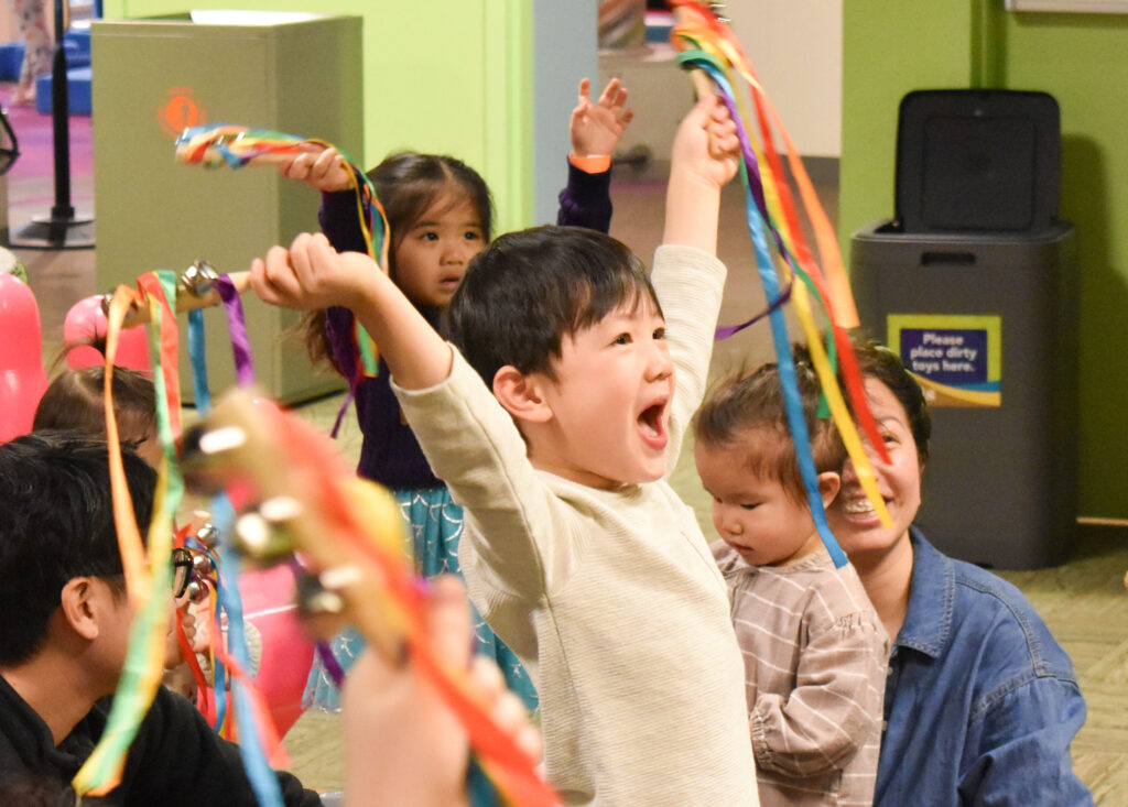 a boy holding a streaming, cheering